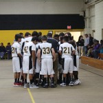 A group of boys in a basketball huddle.