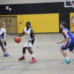 Boys' basketball team playing energetically on the court.