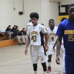 Boys basketball team playing on the court.