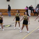 Cheerleaders in action at NMSHS basketball game, showcasing their spirit and energy.