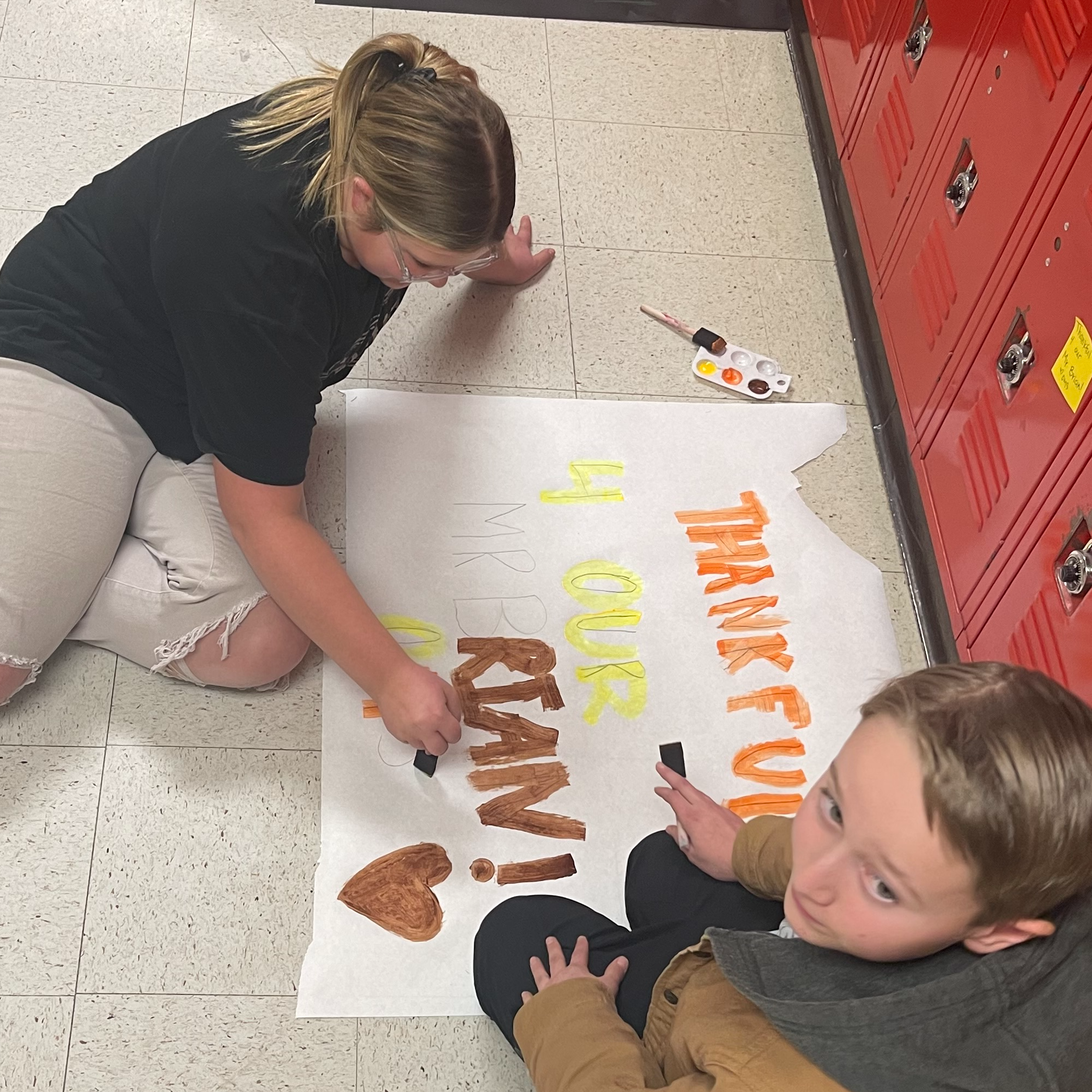 Students painting signs