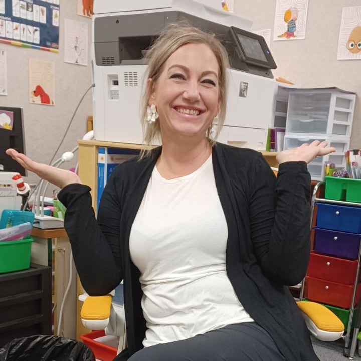 Teacher sitting in golden chair  posing.