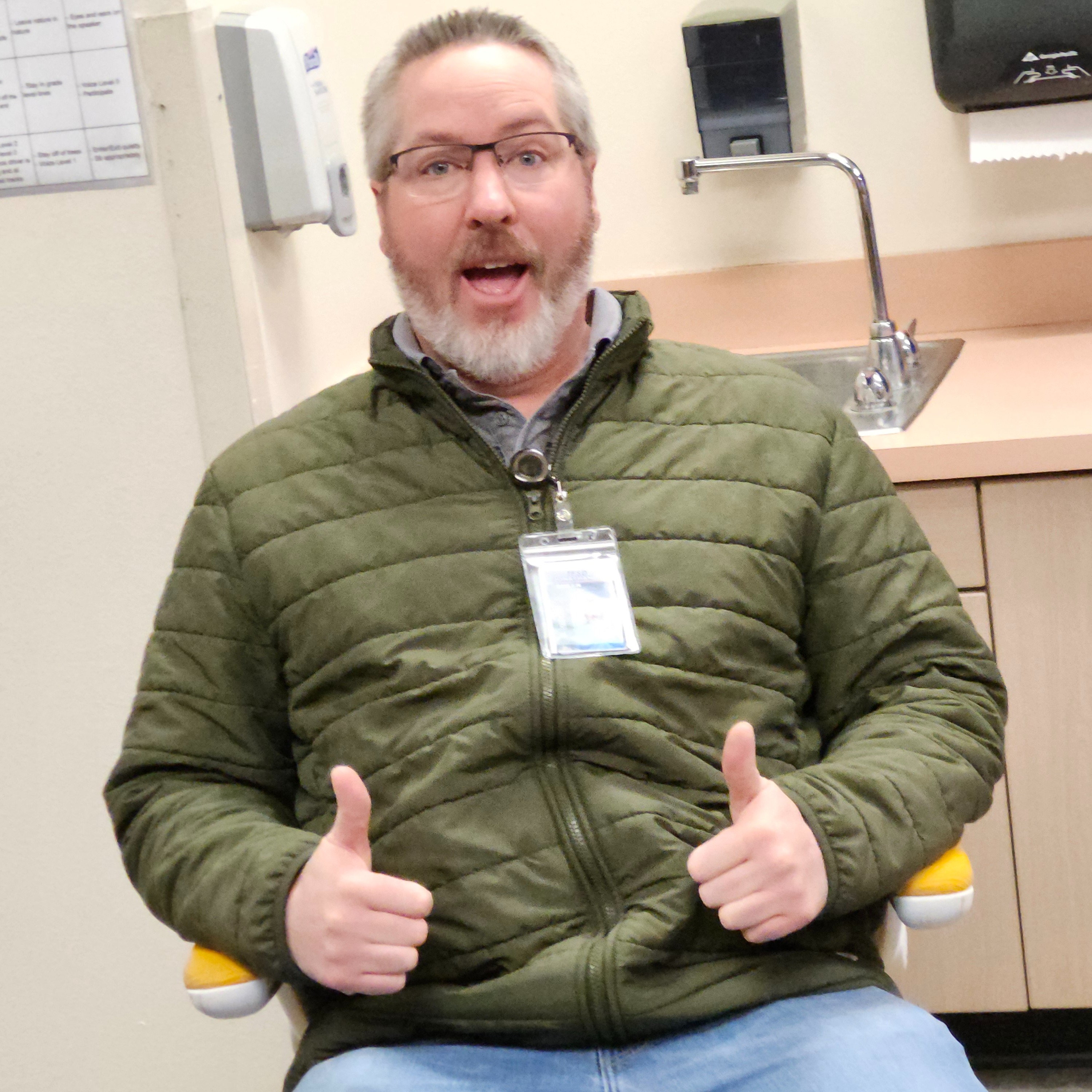 Teacher sitting in golden chair  posing.