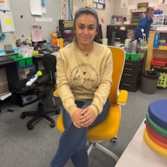 Teacher posing in Golden Chair