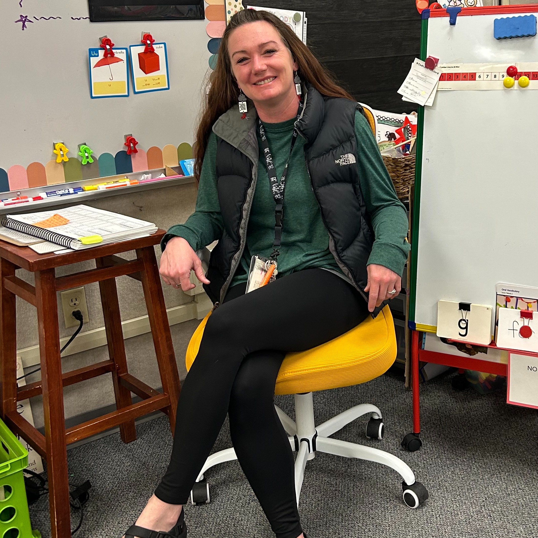 Teacher sitting in golden chair  posing.