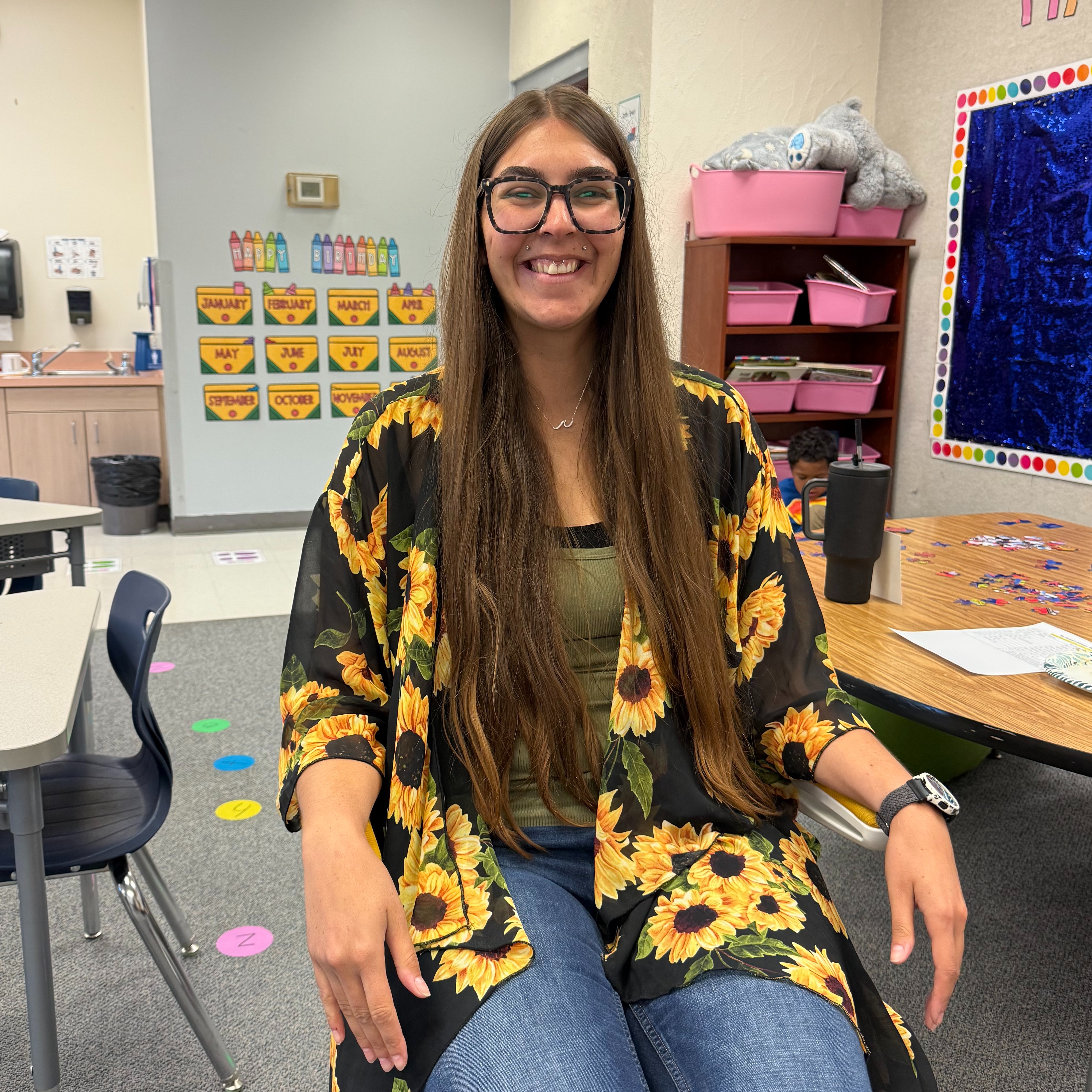 Teacher sitting in golden chair  posing.