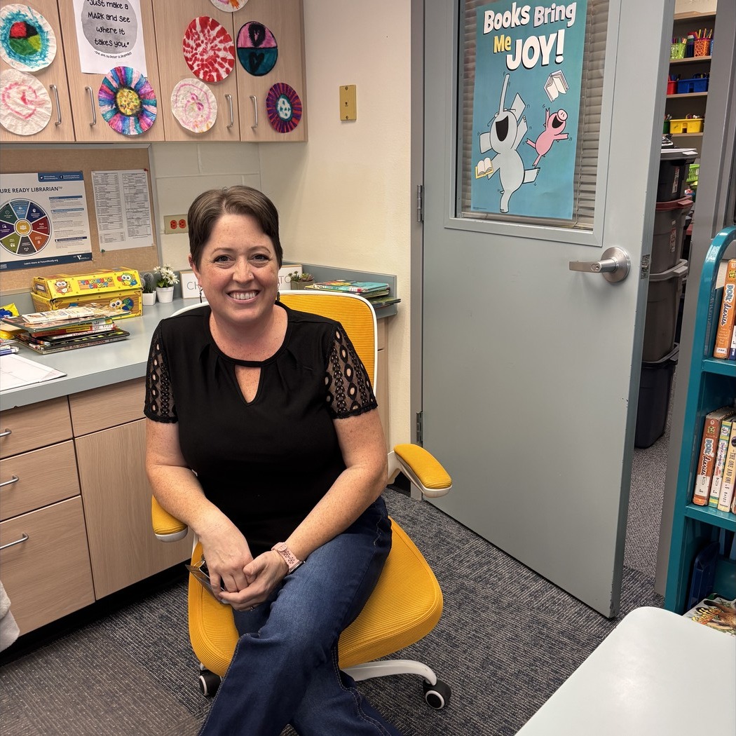 Teacher Smiling in Golden Chair