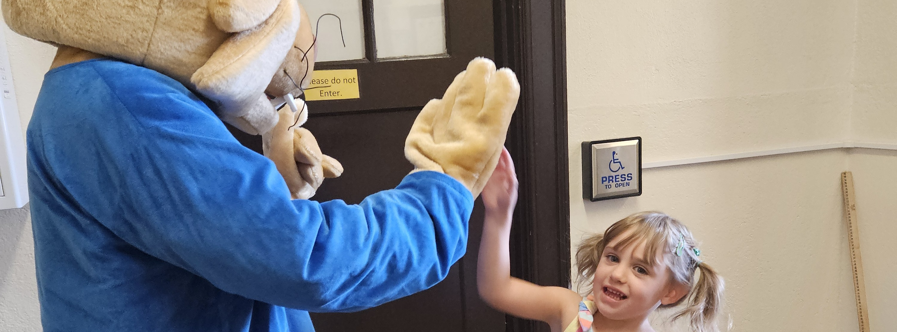 Mascot highfiving student