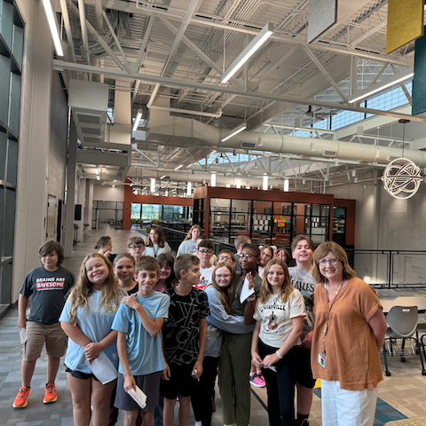 Photo of group of middle school students with their teacher Allison Brooks