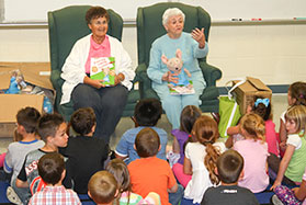 ladies reading to a group of kids