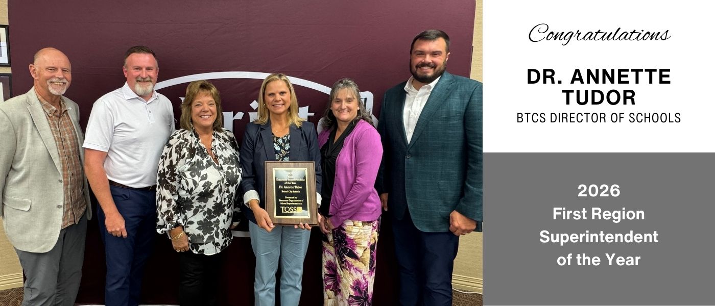"A group of six people stand together smiling in front of a maroon backdrop. Dr. Annette Tudor, holding a plaque, is recognized as the 2026 First Region Superintendent of the Year. Text on the right side of the image reads: 'Congratulations Dr. Annette Tudor, BTCS Director of Schools, 2026 First Region Superintendent of the Year.'"