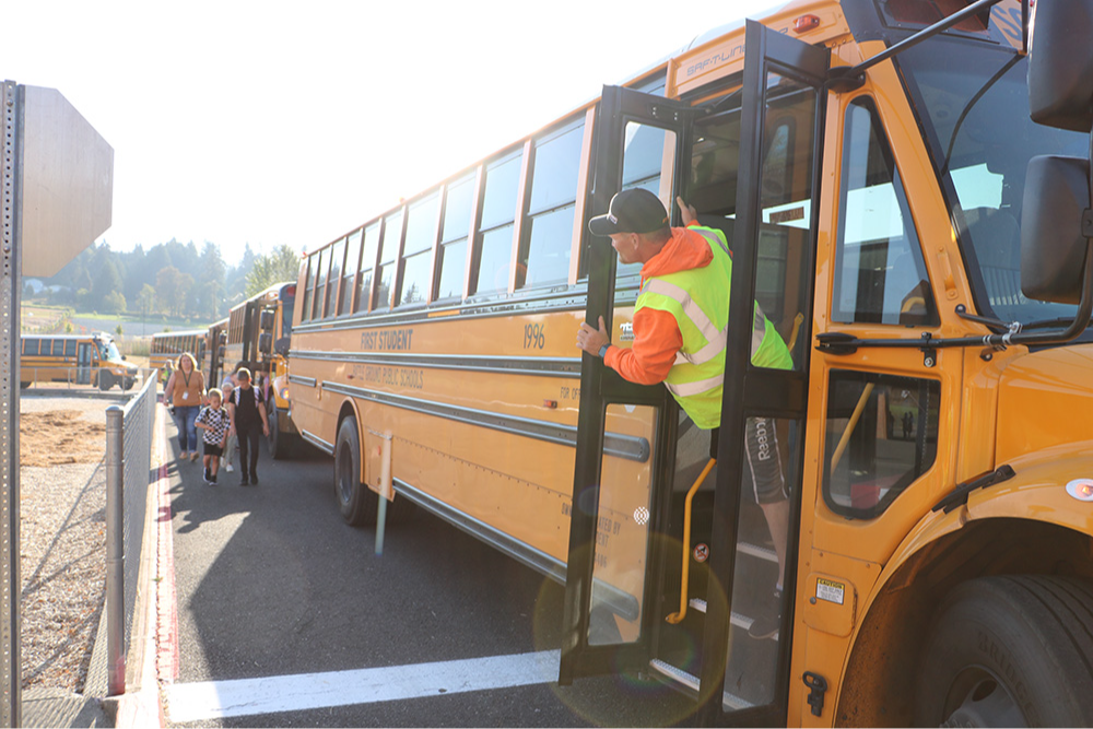 Bus driver greets students