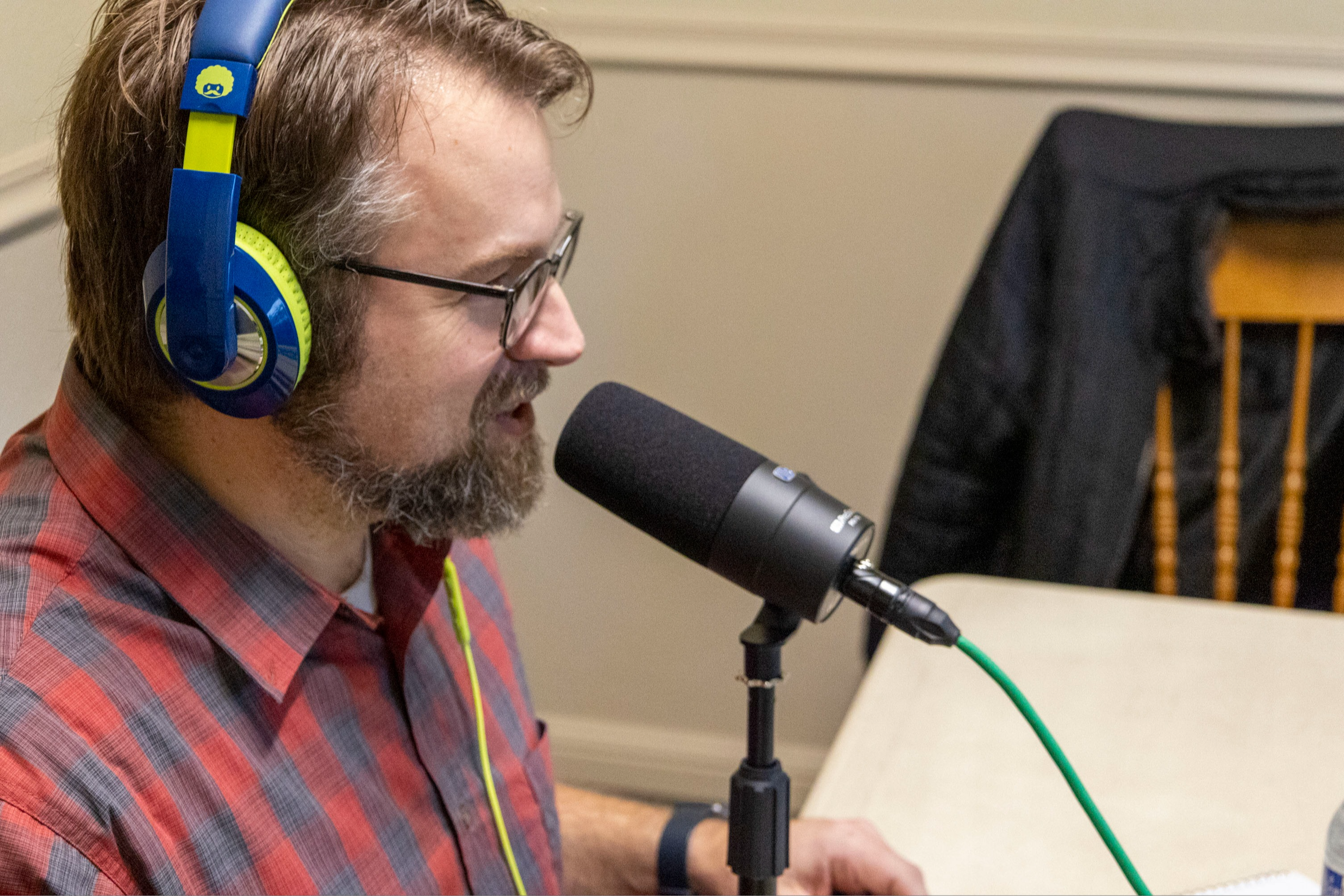 Podcast host David Lindner speaks into the microphone