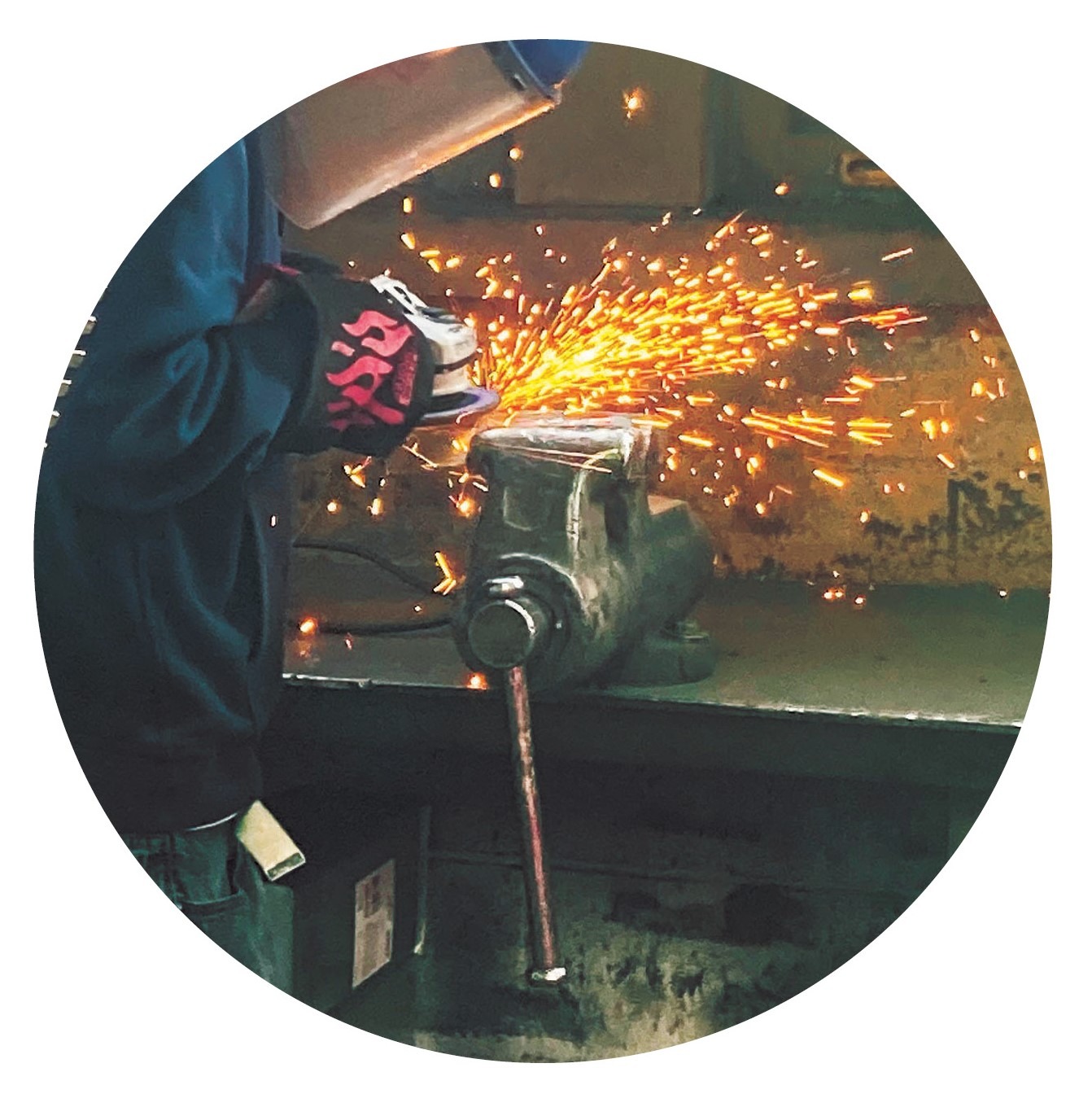 Student working on a grinder in welding class