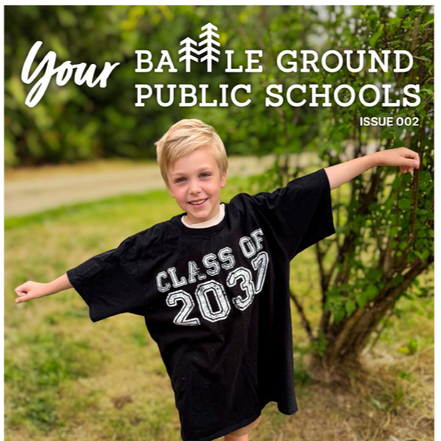 Child smiling wearing a too-big black shirt