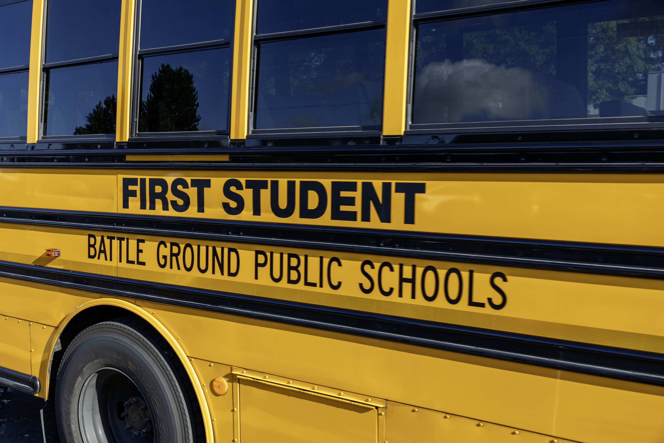 Side of a bus that reads, "First Student; Battle Ground Public Schools"