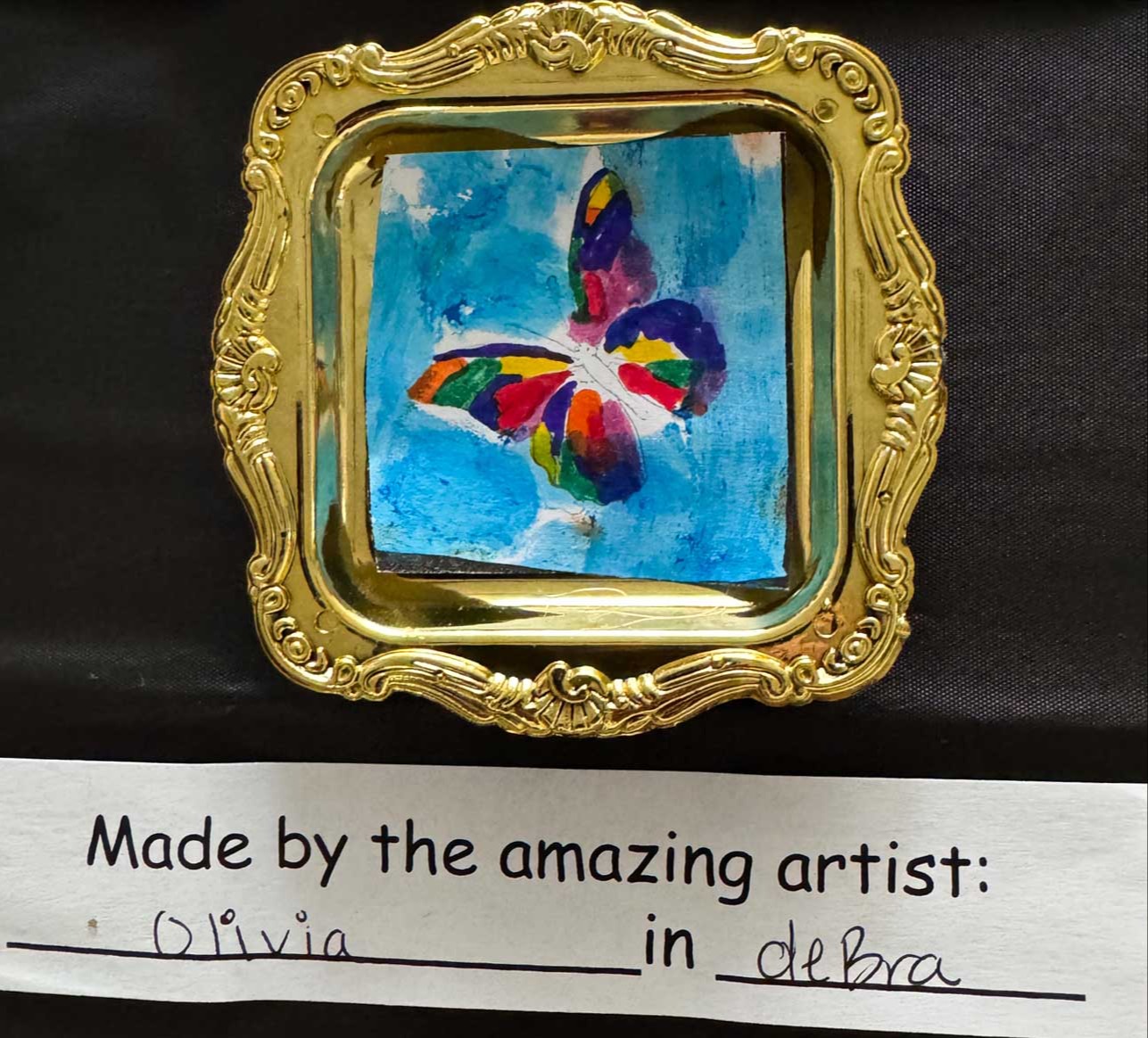 small painted butterfly in a gold tray