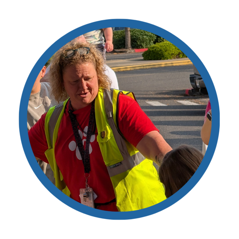 A principal directs students and families on the first day of school