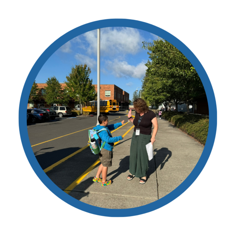 A student high fives a staff member