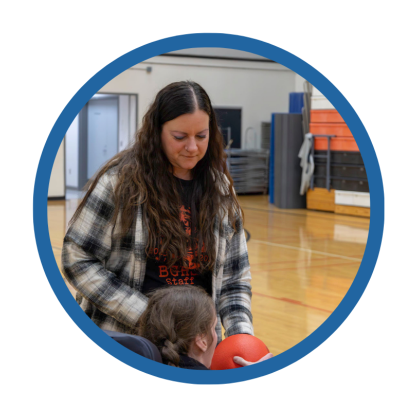 A staff member works with a student