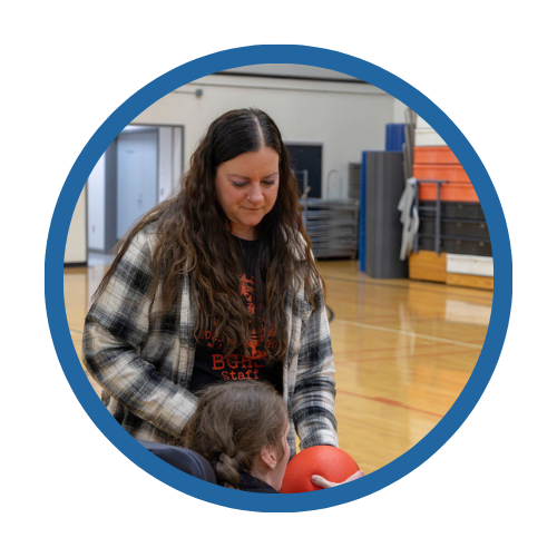 A staff member helps a student