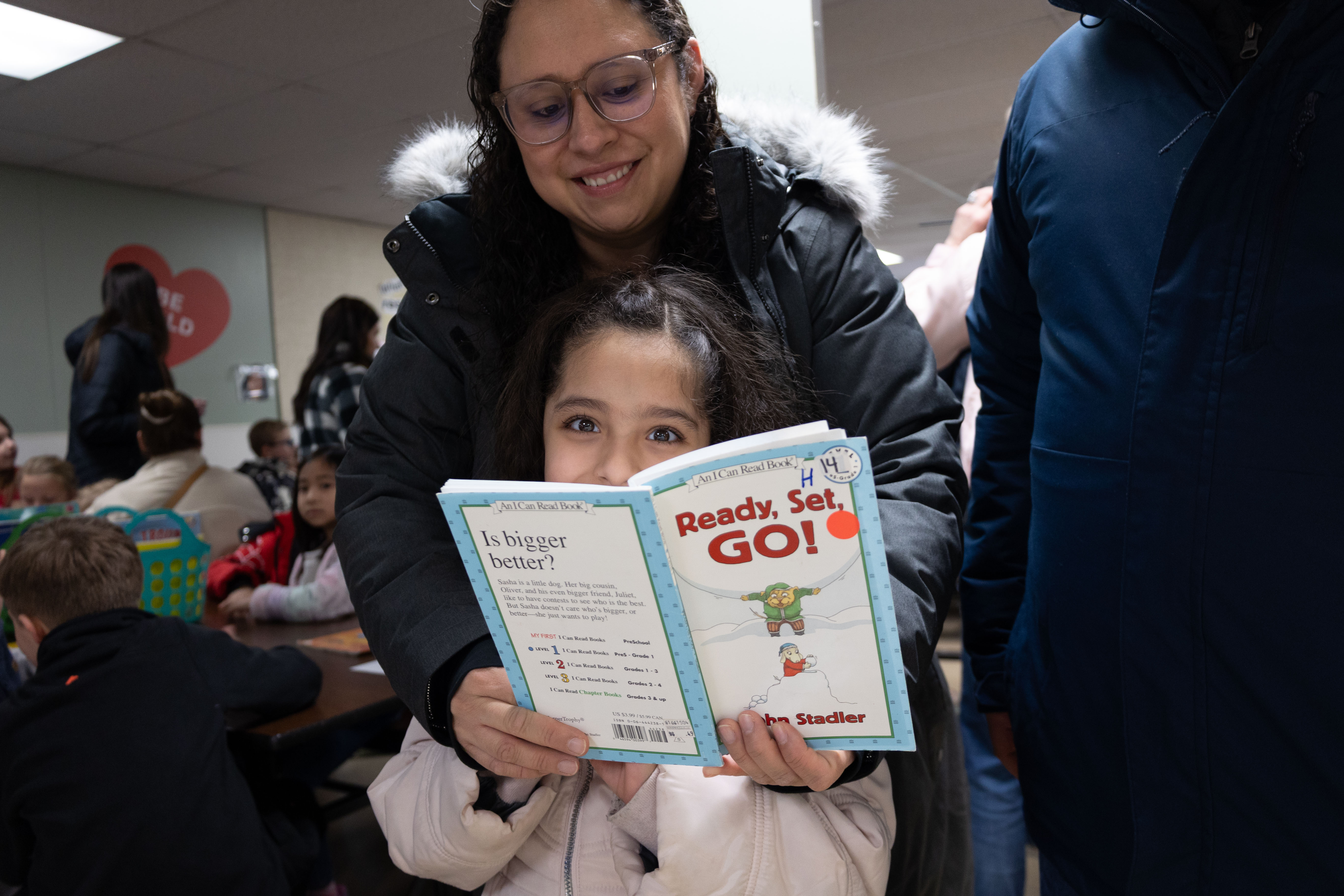 A student and adult read a book together