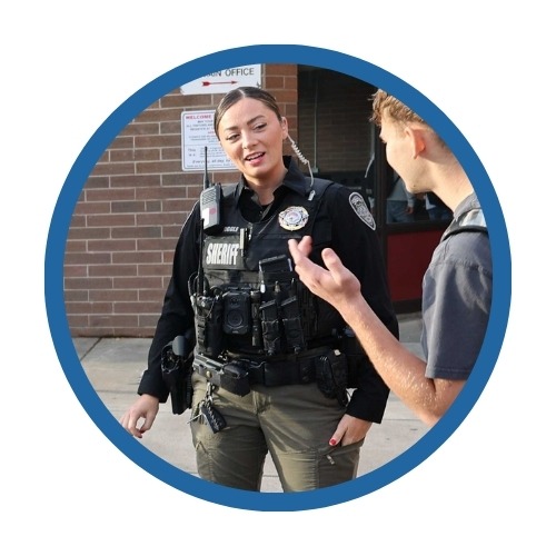 A school resource officer talks with a student