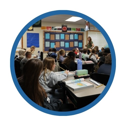 A teacher works with students in a classroom