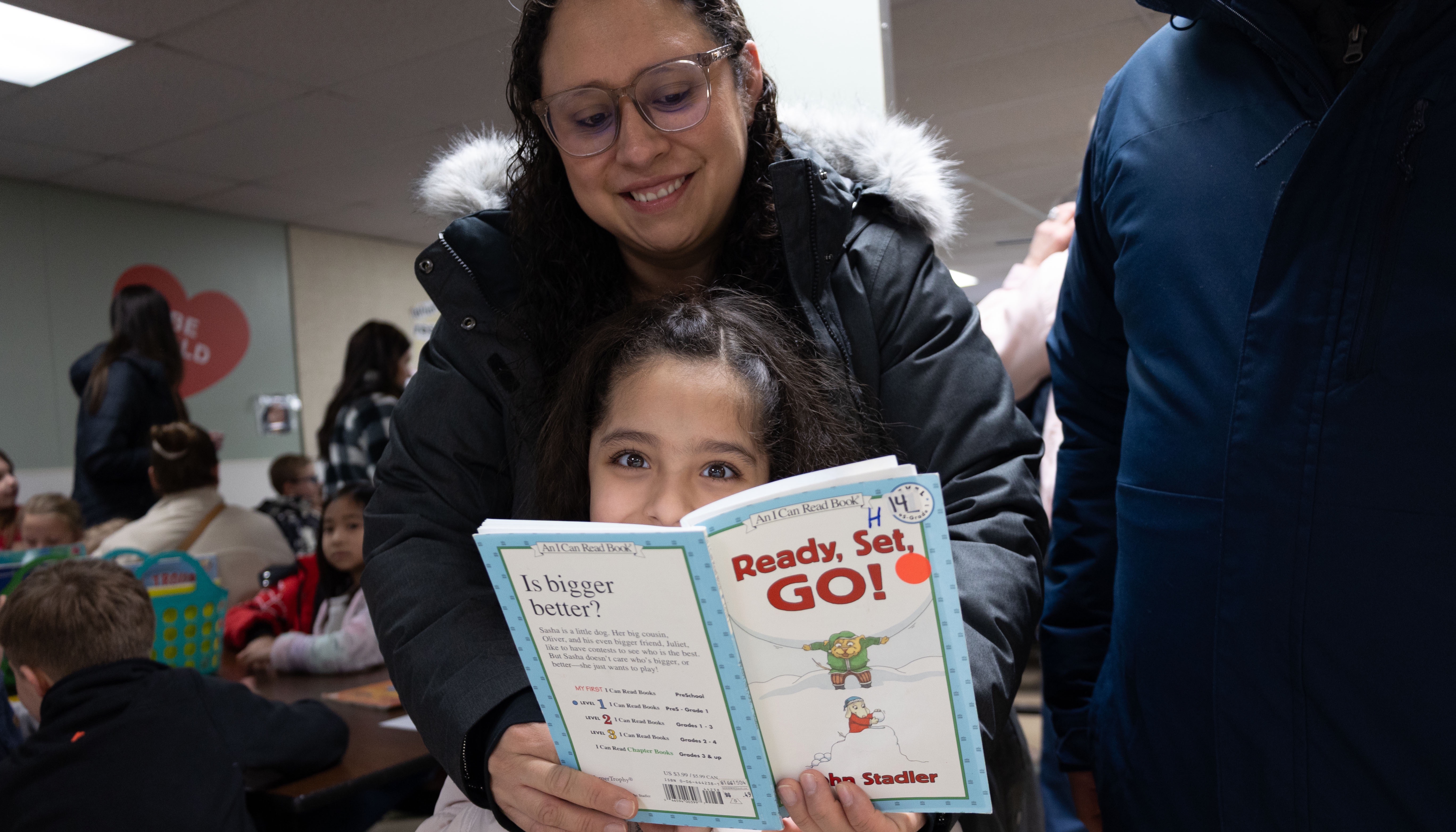 A student and parent read a book