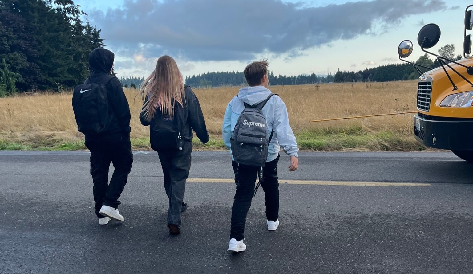 Students wait for the school bus to arrive
