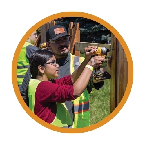A student works on a fence building project