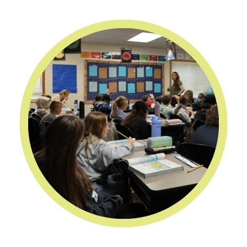 A teacher works with students in a classroom