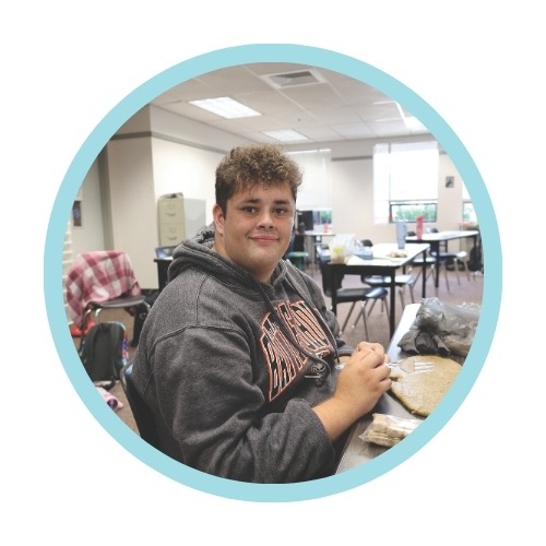 A student looks at the camera