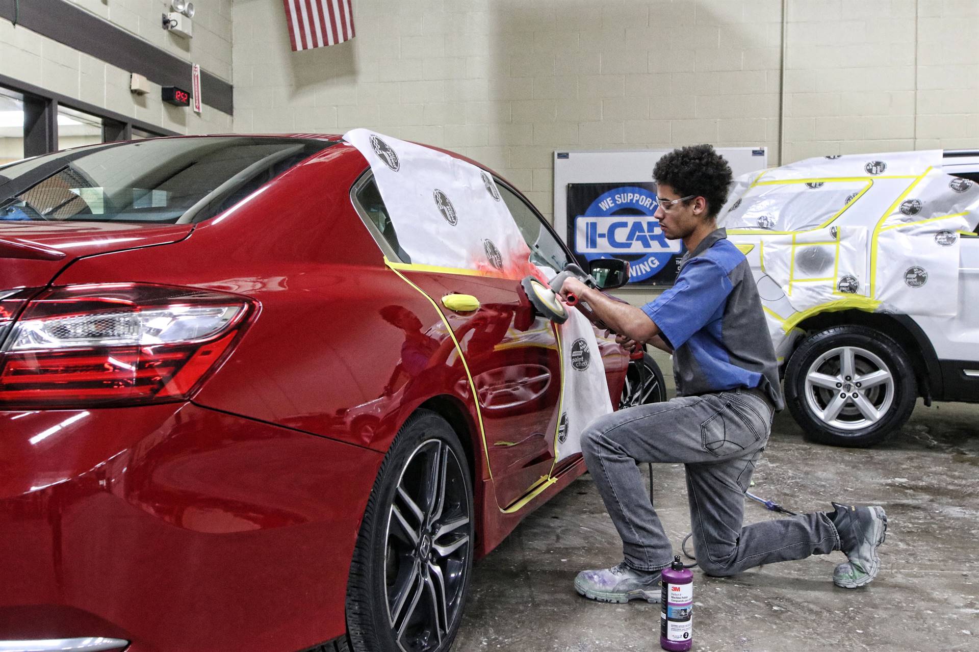 guy cleaning a red car