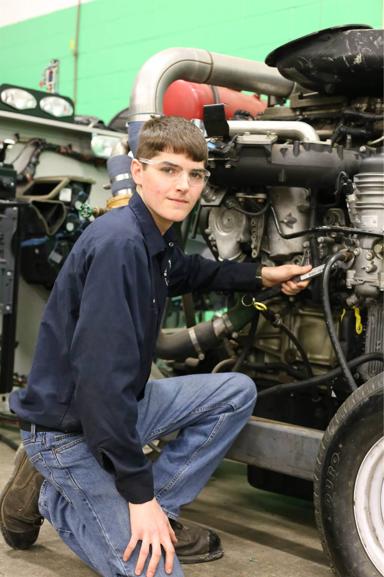 boy reparing a motorcycle