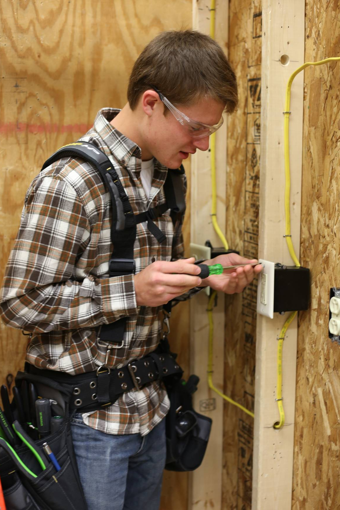 boy with tools fixing a light connection