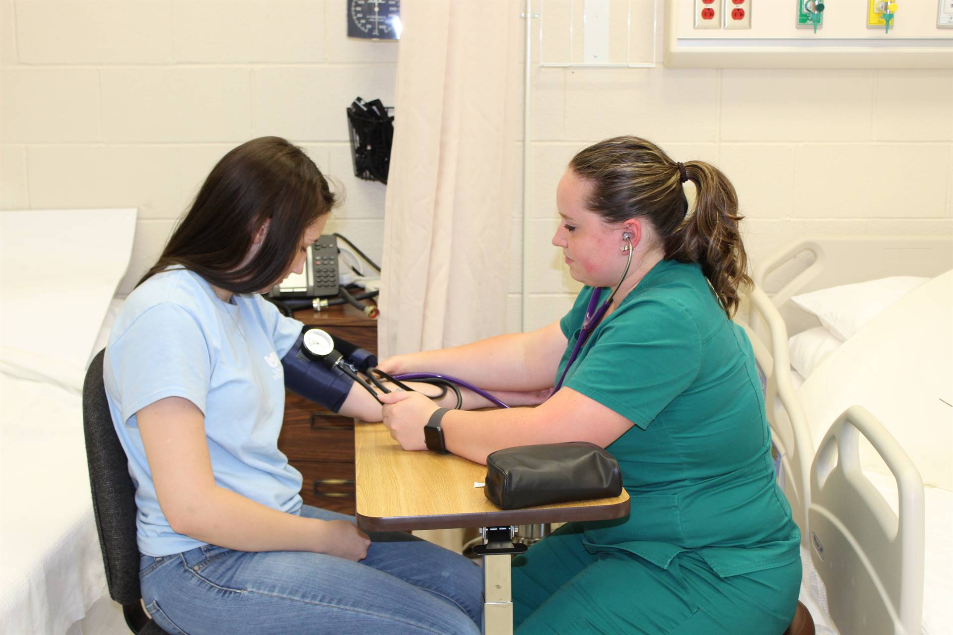 nurse checking the pulse on a woman