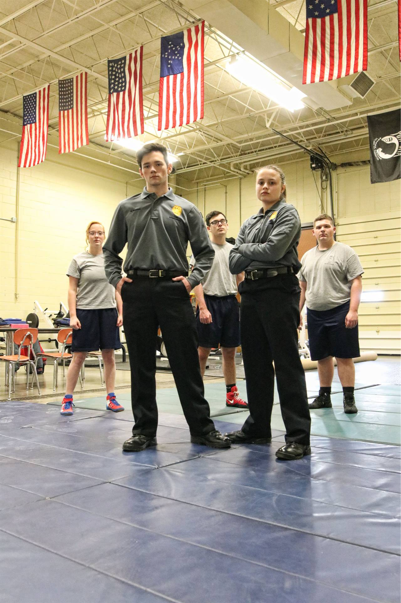 5 students standing in a gym as the law enforcement team