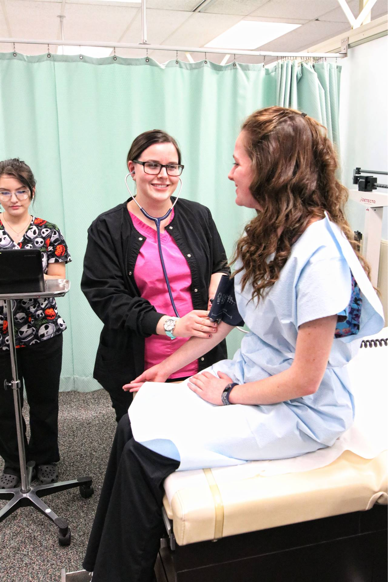 nurse giving medical assistance to a girl in a bed