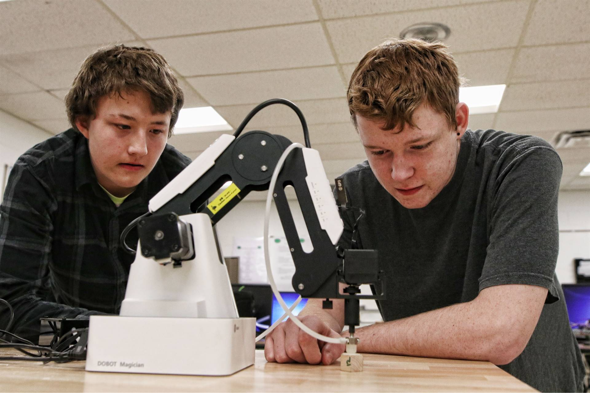 2 students looking at a microscope 