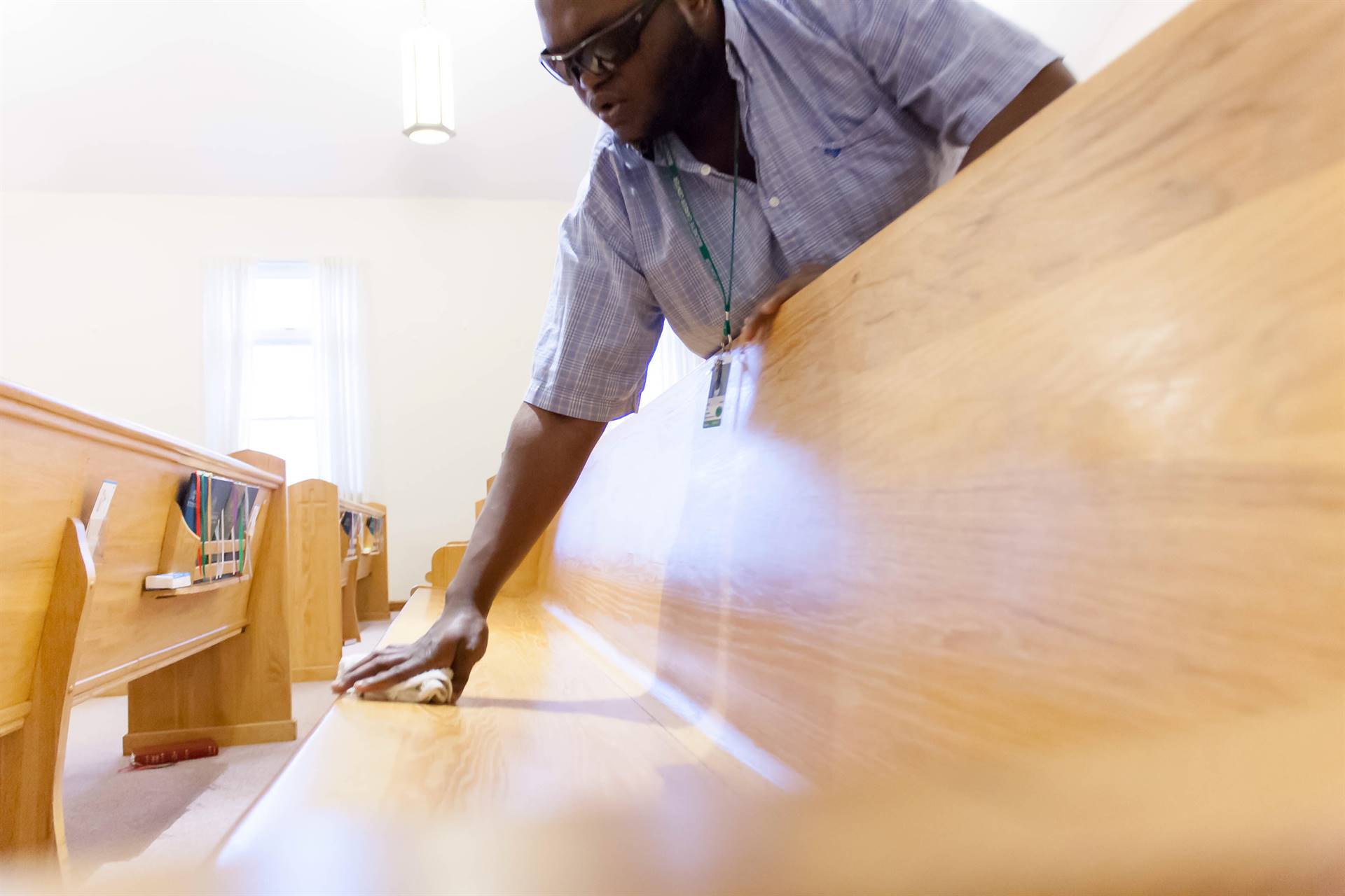 man touching a wooden long chair