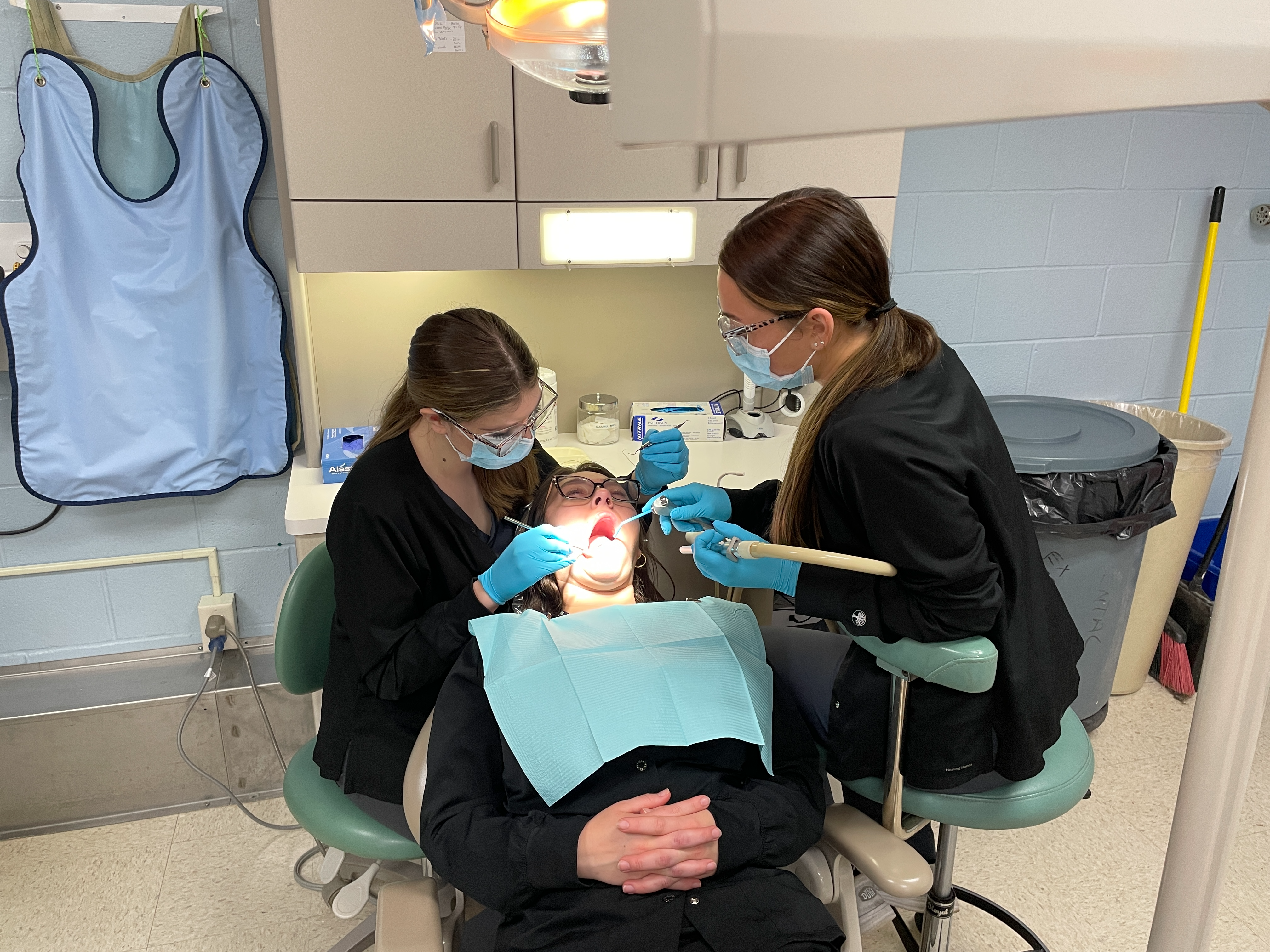 students cleaning teeth