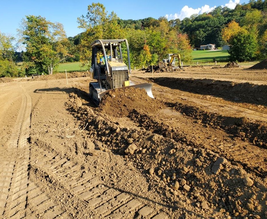 bulldozer pushing a pile of dirt