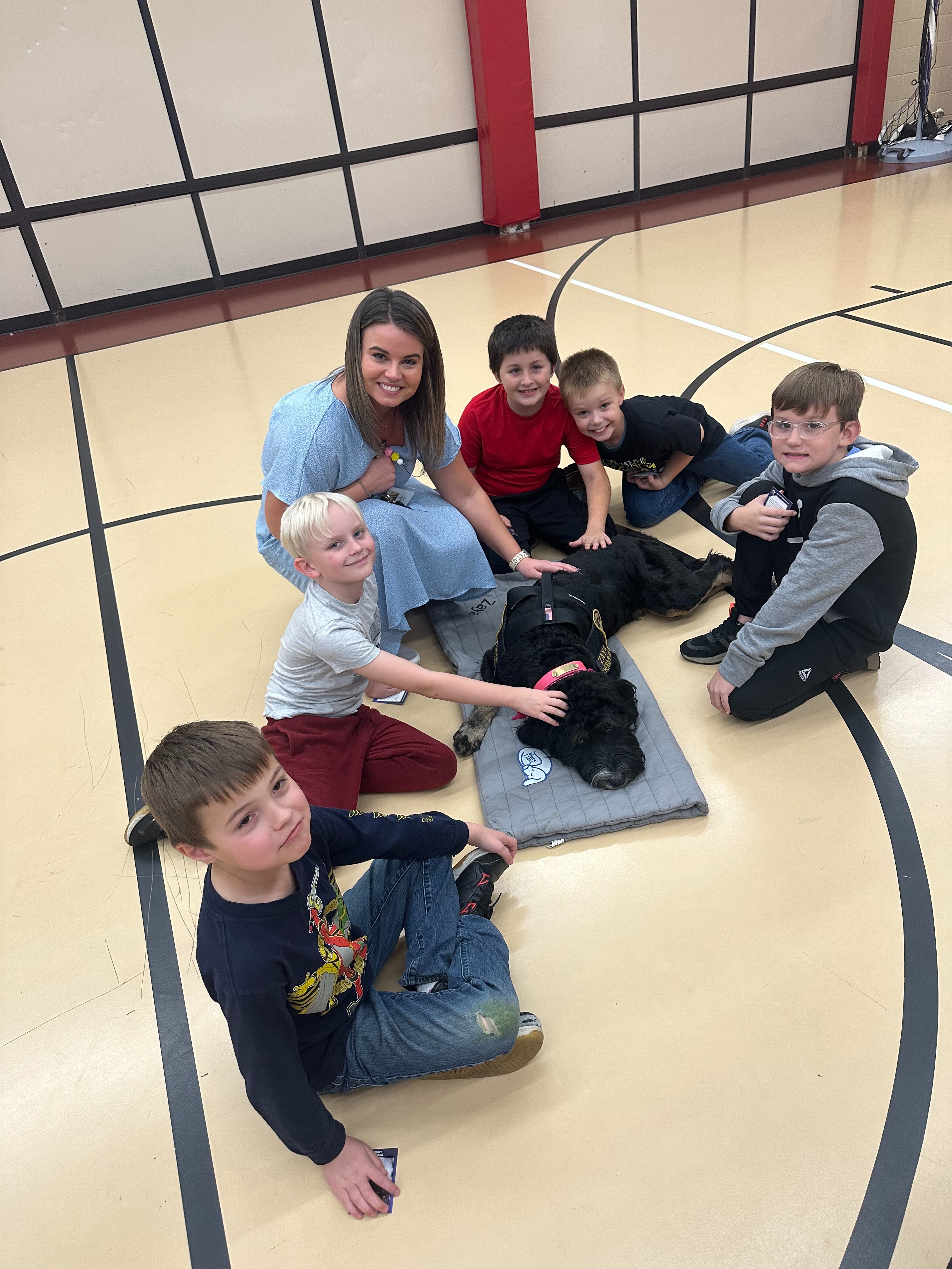 Students and Teacher petting the K9 Unite Dog