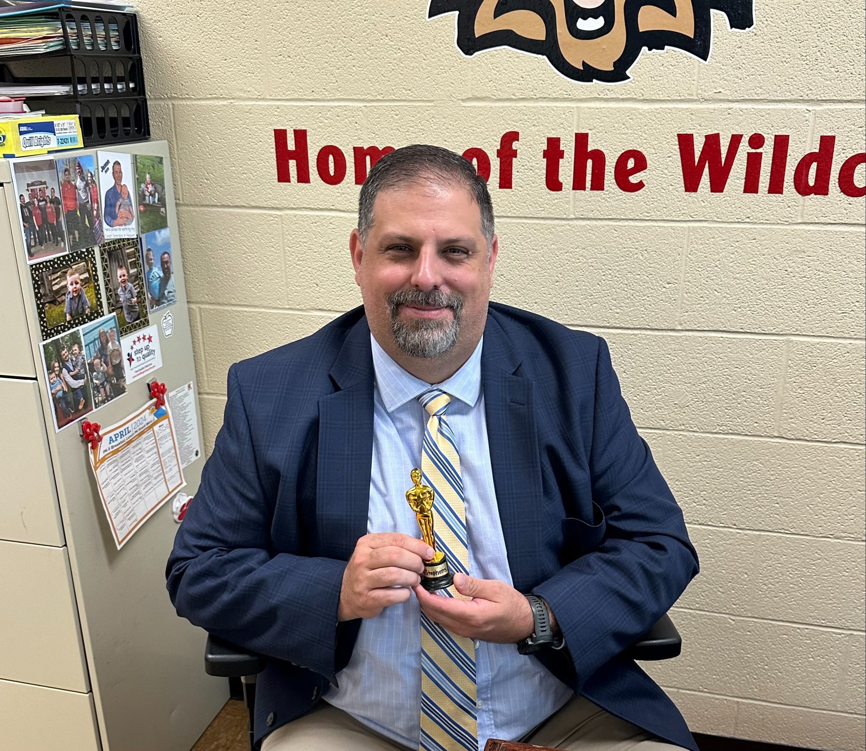 Principal holding an Award 