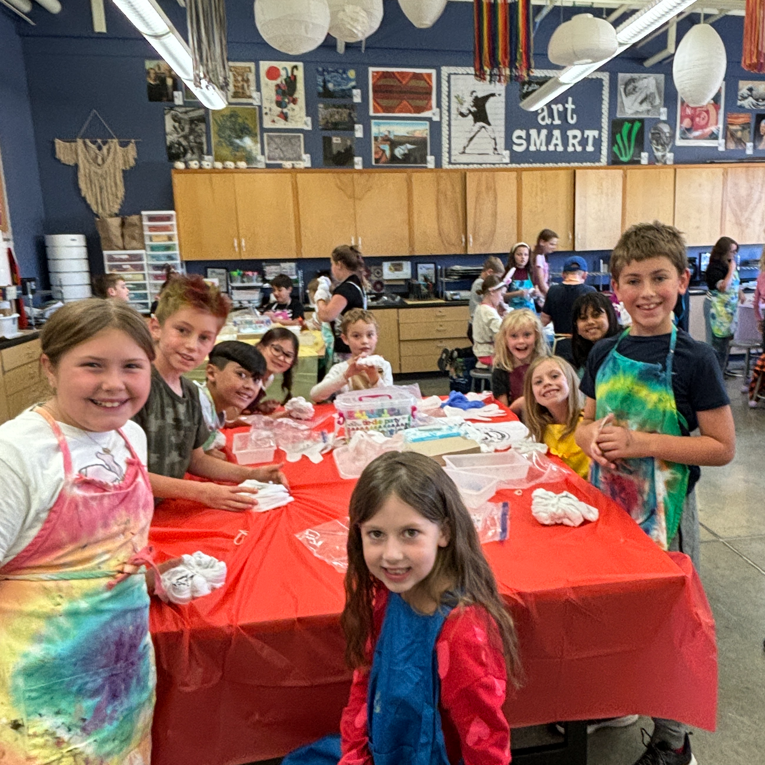 Students tie-dyeing tshirts together