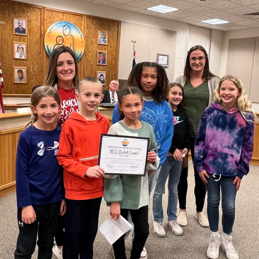 Group Photo of Students receiving an award in the board room.