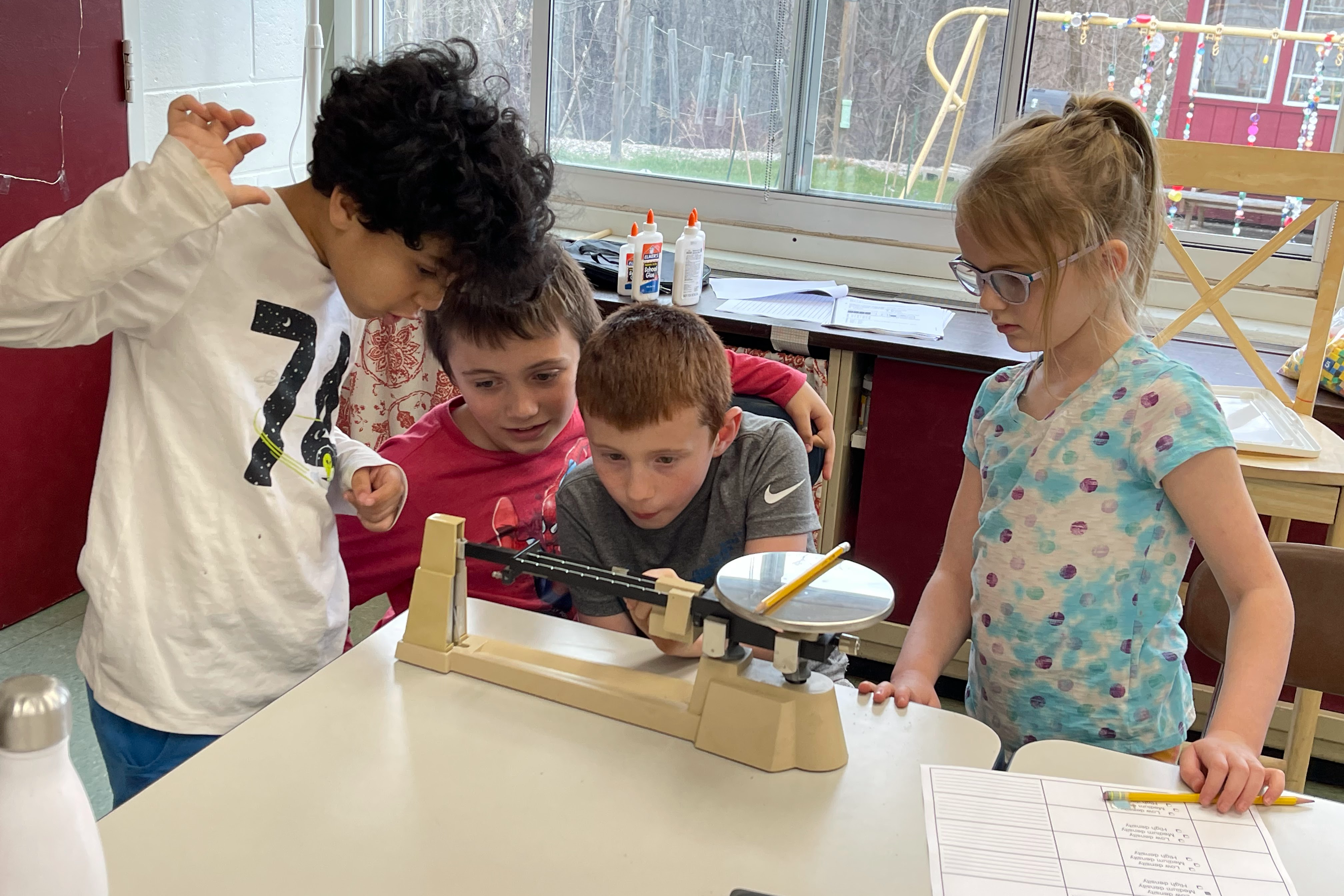 kids using a triple beam balance