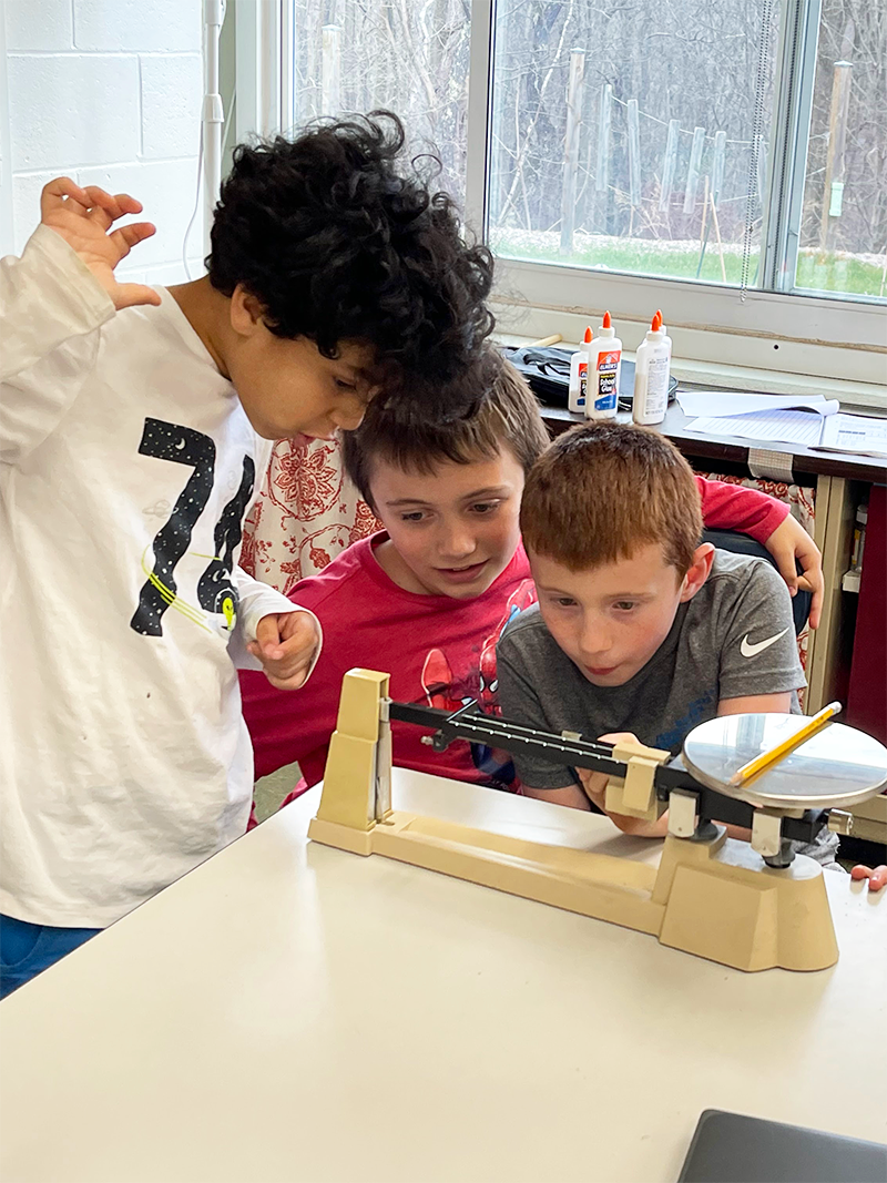 kids using a triple beam balance