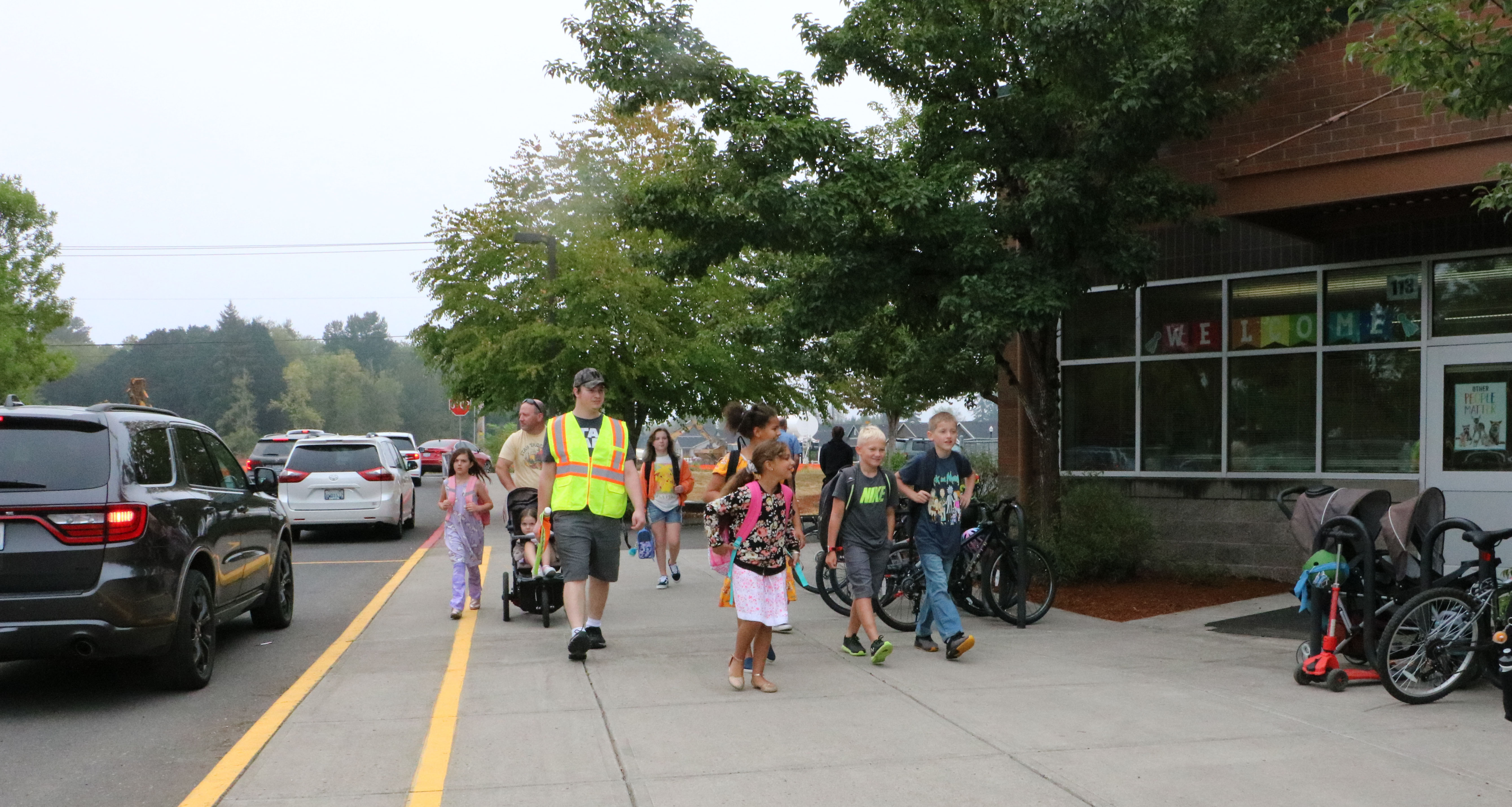 Students and parents walk into school